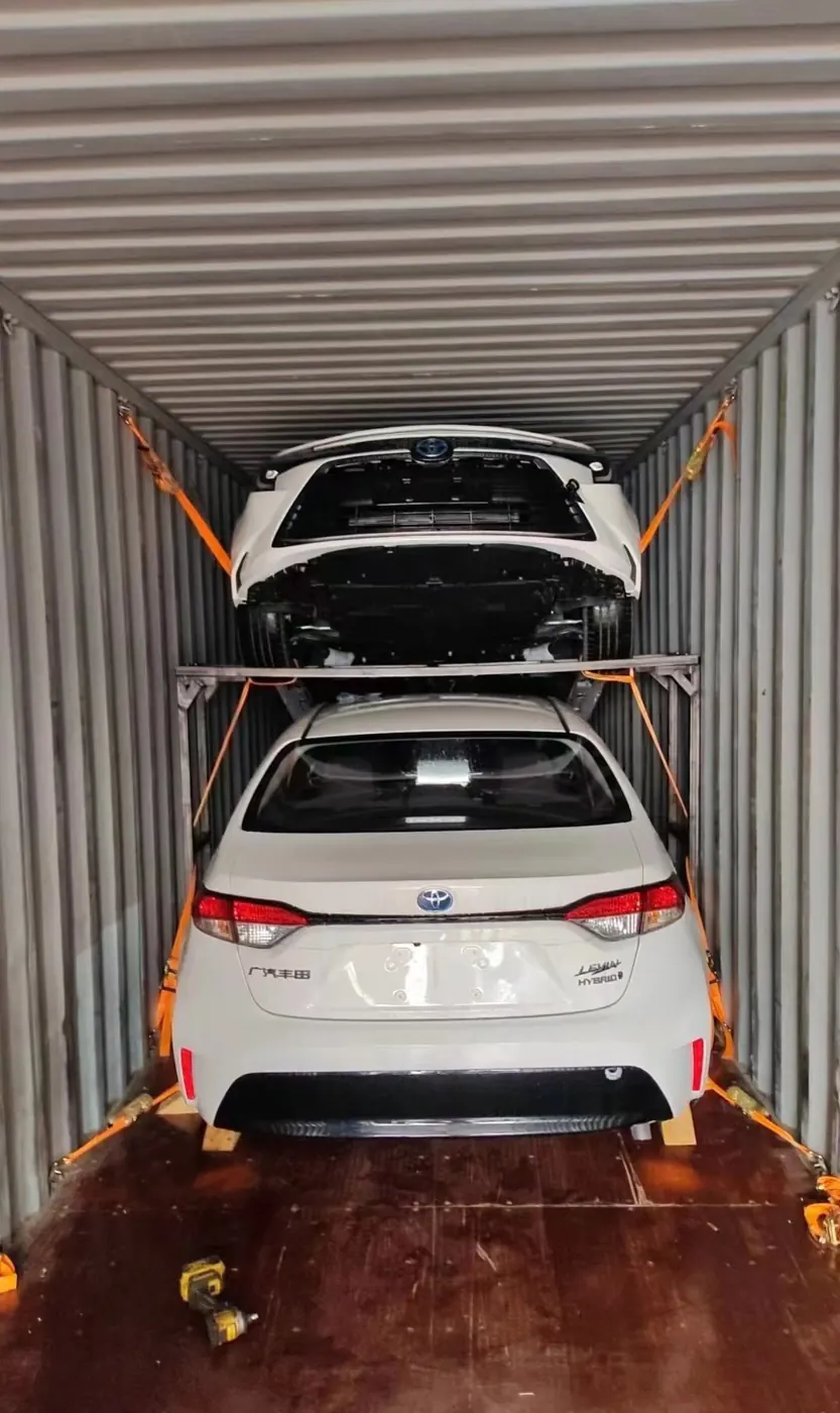 Two vehicles on a two-tier rack inside a container